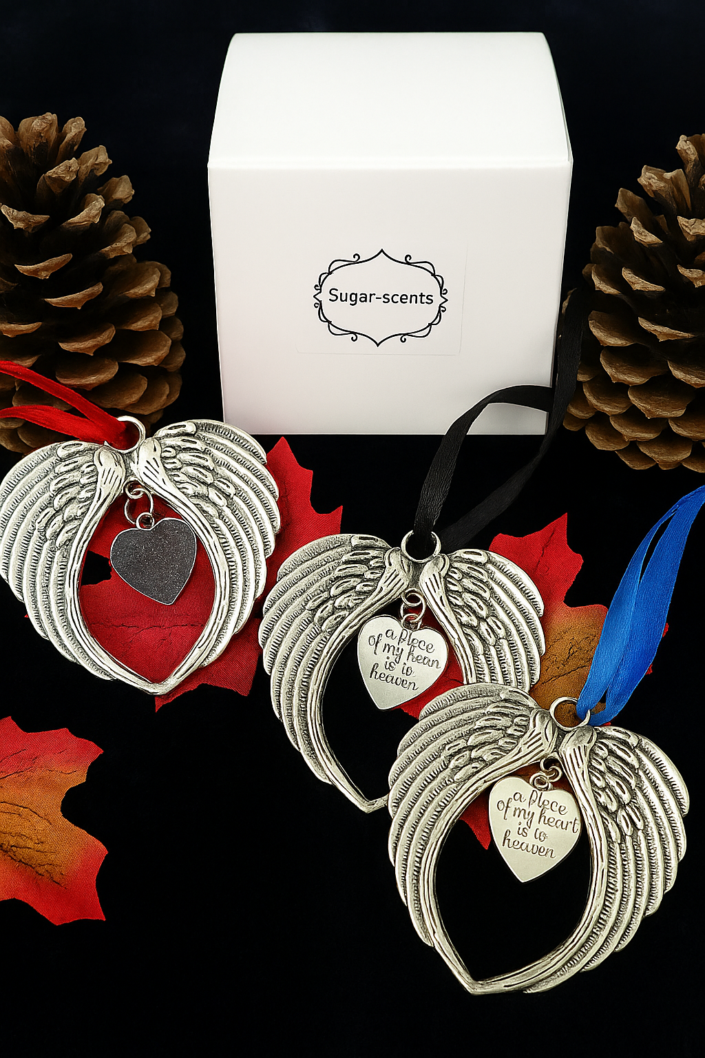 Memorial Wings angel wing ornaments with heart, styled with pine cones and autumn leaves